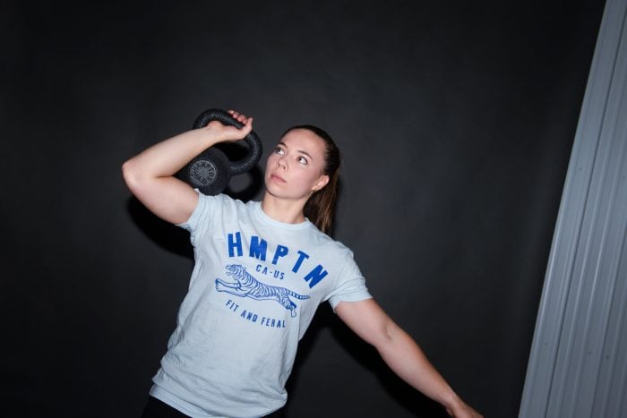 Female athlete lifting a Hampton urethane kettlebell.