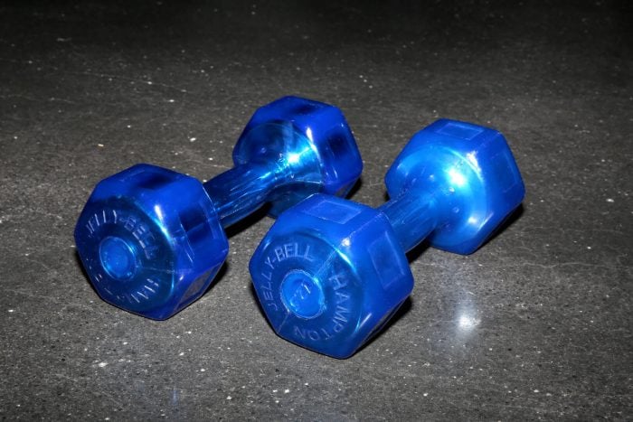 Front view of a pair of blue Hampton Jelly-Bells lying on a gym floor.