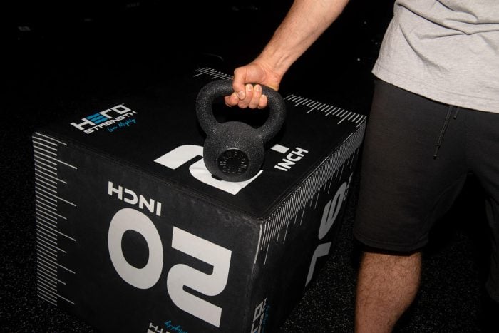 Image of a weightlifter gripping a Hampton urethane kettlebell.