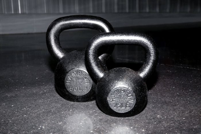 Front view of a set of Hampton Urethane kettlebells resting on a gym floor.