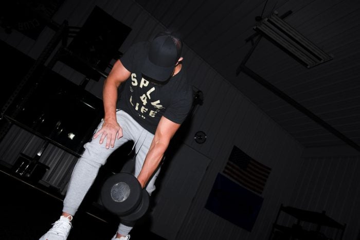 Athlete lifting a Hampton Gel-Grip Dumbbell off the gym floor.