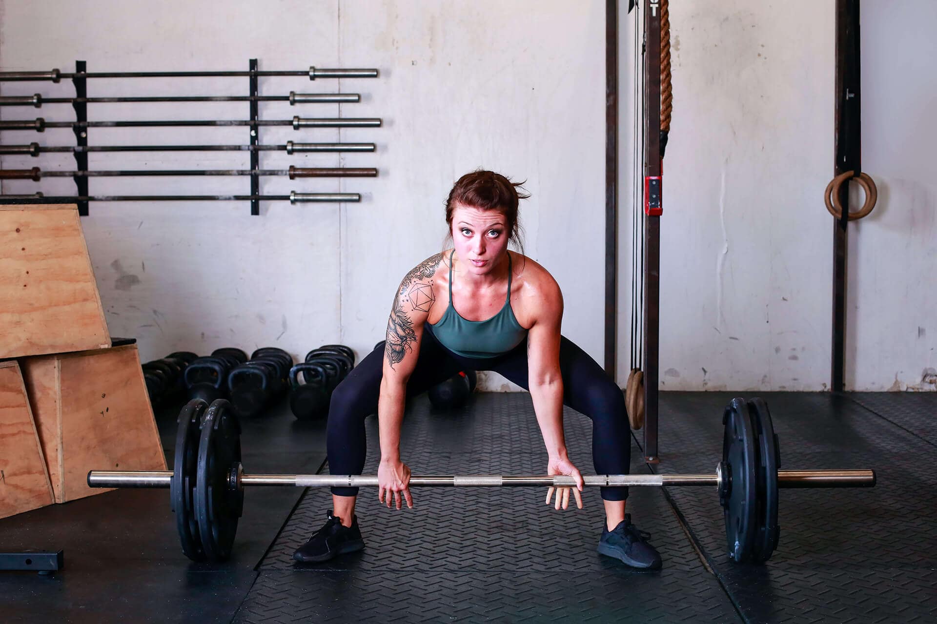 woman performing dead lifts with the Hampton Olympic bar and plates