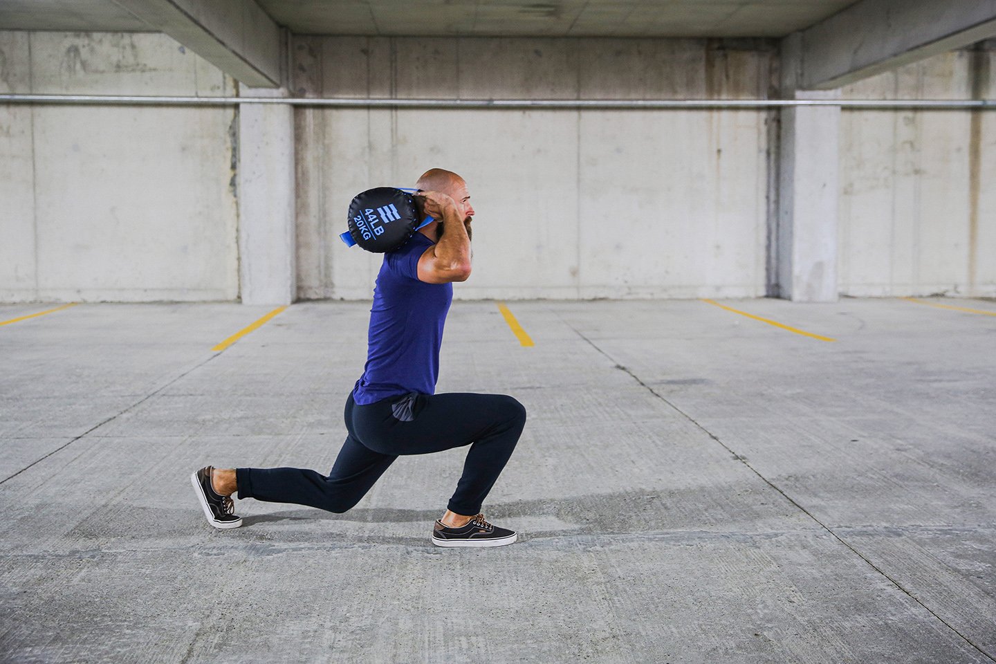 hampton athlete performing lunges with the Herostrength action bag