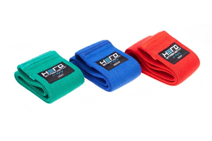 group of power bands in various weights and colors - green, blue, and red.