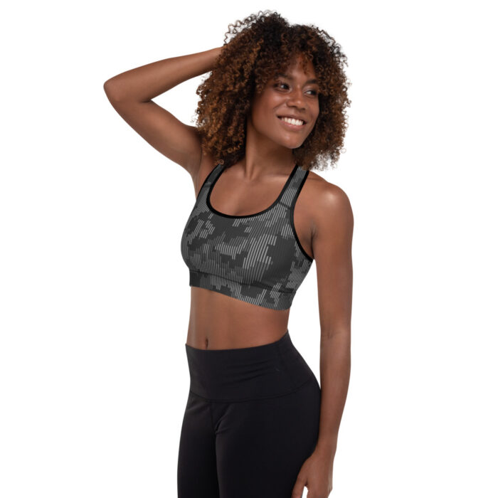 African American woman with short natural hair, side facing camera, shades of gray camo racerback sports bra with black leggings