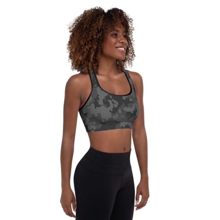 African American woman with short natural hair, side facing camera, shades of gray camo racerback sports bra with black leggings