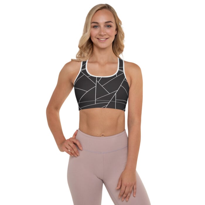 blonde woman, black and white racerback bra with geometric designs, facing forward and muted mauve leggings