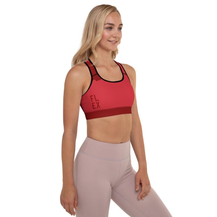 blonde woman facing front with red sports bra and muted mauve leggings