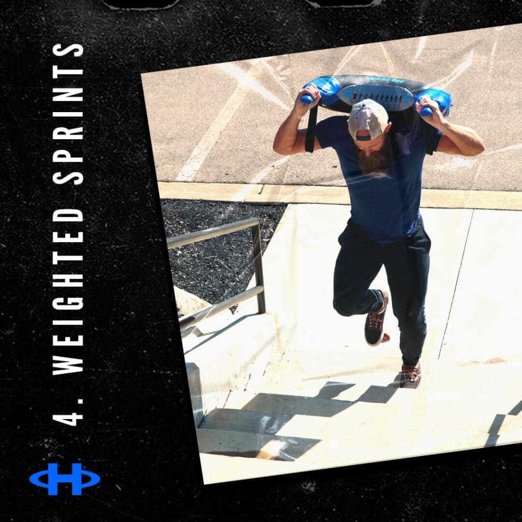 Man running up stairs while carrying a "Rescue" bag on his shoulders.